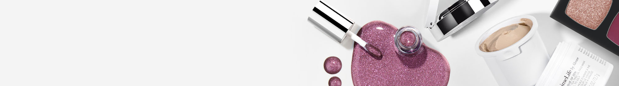 LimeLife makeup and skincare products on a gray background