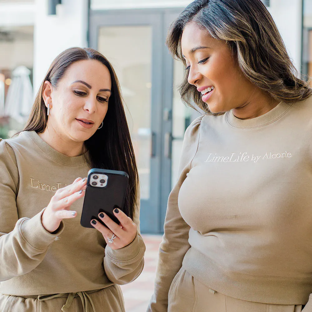 A LimeLife Beauty Guide working from her phone