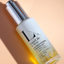 Bottle of LimeLife's One Drop Wonder on a peach background.